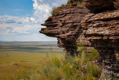 Rock in khakassia, russia. view of the steppe from the cliff.