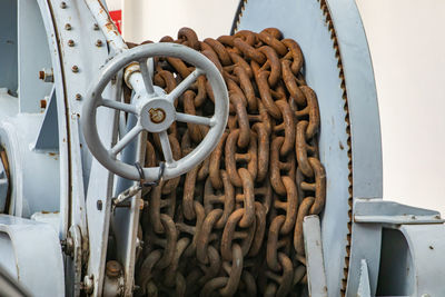 Close-up of rope tied up on metal chain