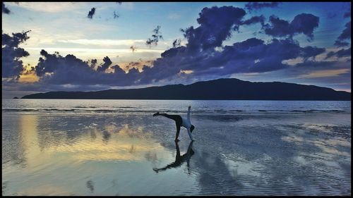 Scenic view of lake against cloudy sky