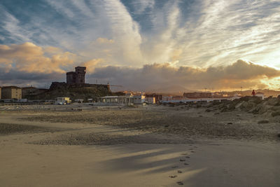 Scenic view of beach against sky during sunset