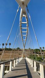 View of suspension bridge against clear blue sky