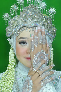 Portrait of smiling young bride wearing hijab and wearing a crown