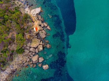 High angle view of rock by sea