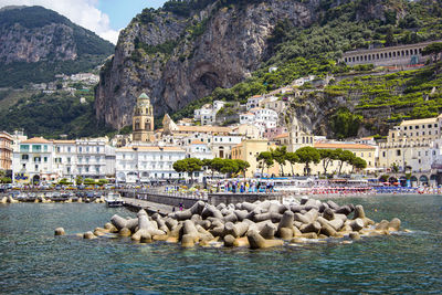 Aerial view of small haven of amalfi village with turquoise sea and colorful houses on slopes 