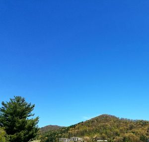 Scenic view of mountains against clear blue sky