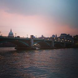 Bridge over river with buildings in background