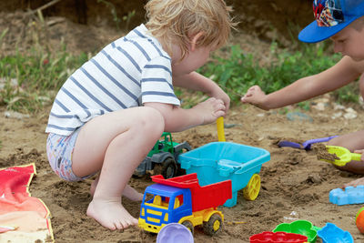 Children playing with toy on sand