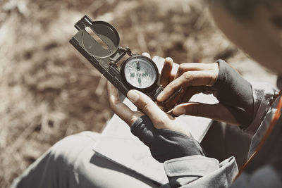 High angle view of man holding clock