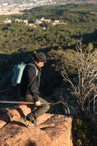 Man descends the mountain surrounded by the landscape of the garraf natural park.