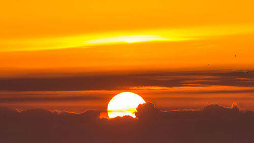 Silhouette mountain against dramatic sky during sunset