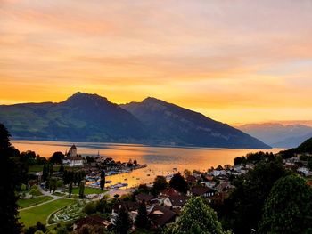 High angle view of townscape by mountains during sunset