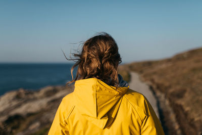 Rear view of woman with umbrella on beach