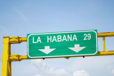 Low angle view of road sign against sky
