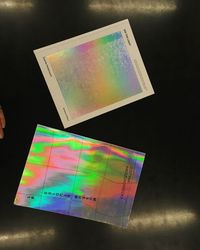 Close-up of multi colored paper against black background