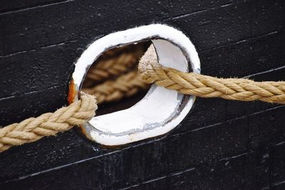 Close-up of rope in hole on wood