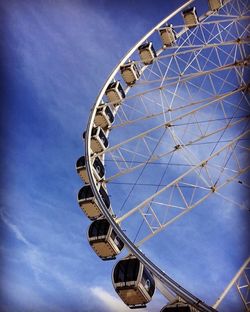 Low angle view of ferris wheel against sky