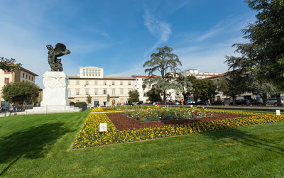 Statue in garden against sky