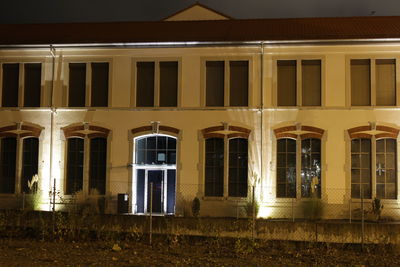 Illuminated building against sky at night