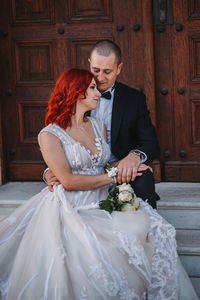 Young couple holding bouquet