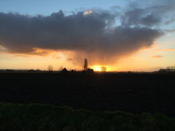 Scenic view of field against sky during sunset