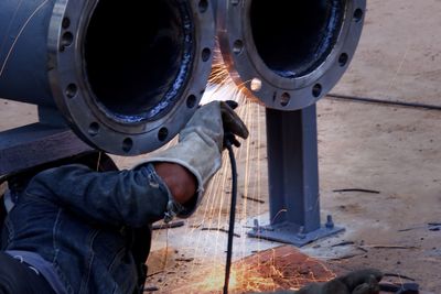 Cropped hand person working at metal workshop