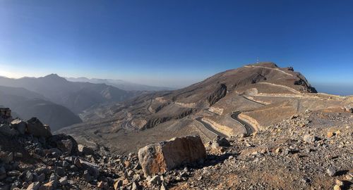 Scenic view of mountains against clear blue sky