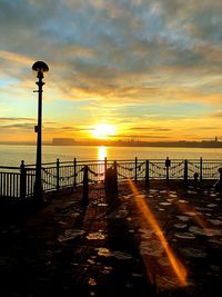 Silhouette pier on sea against sky during sunset