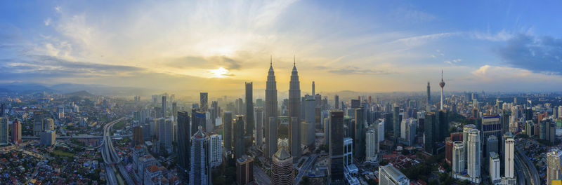 Panoramic view of city against sky during sunset