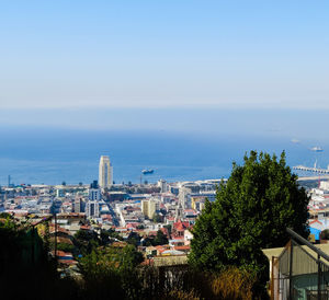 High angle view of buildings and sea against sky