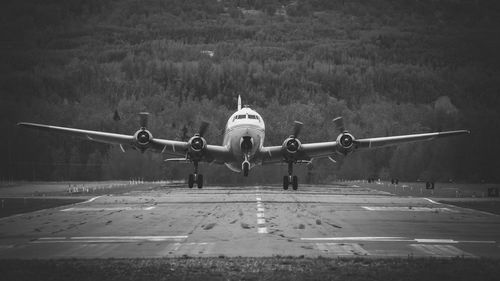 Airplane flying over airport runway