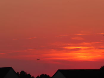 Silhouette of building against sky during sunset