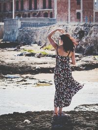 Full length of woman standing at beach