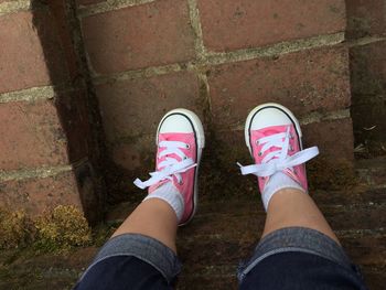 Low section of man standing on cobblestone
