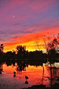 Scenic view of lake against orange sky