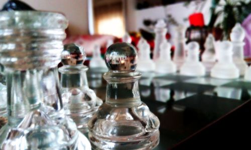 Close-up of chess pieces on table