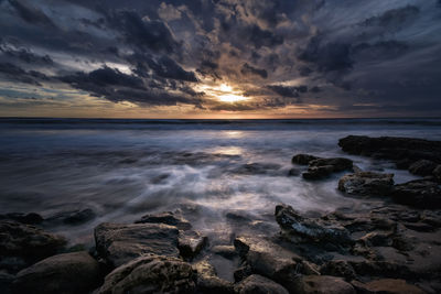 Scenic view of sea against sky during sunset