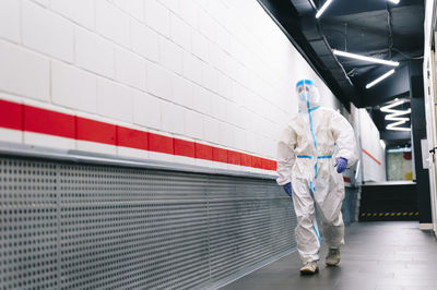 Man walking with face shield in corridor at hospital