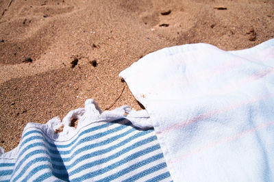 High angle view of towels on sand at beach