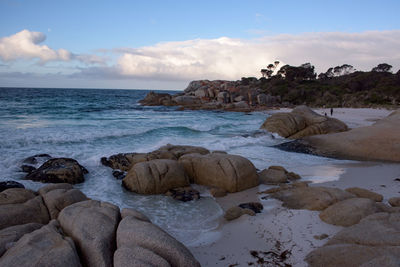 Rocks on beach against sky