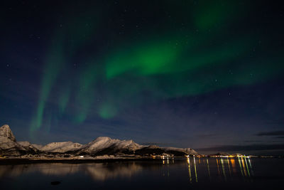 Scenic view of lake against sky at night