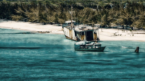 Sailboats moored in sea