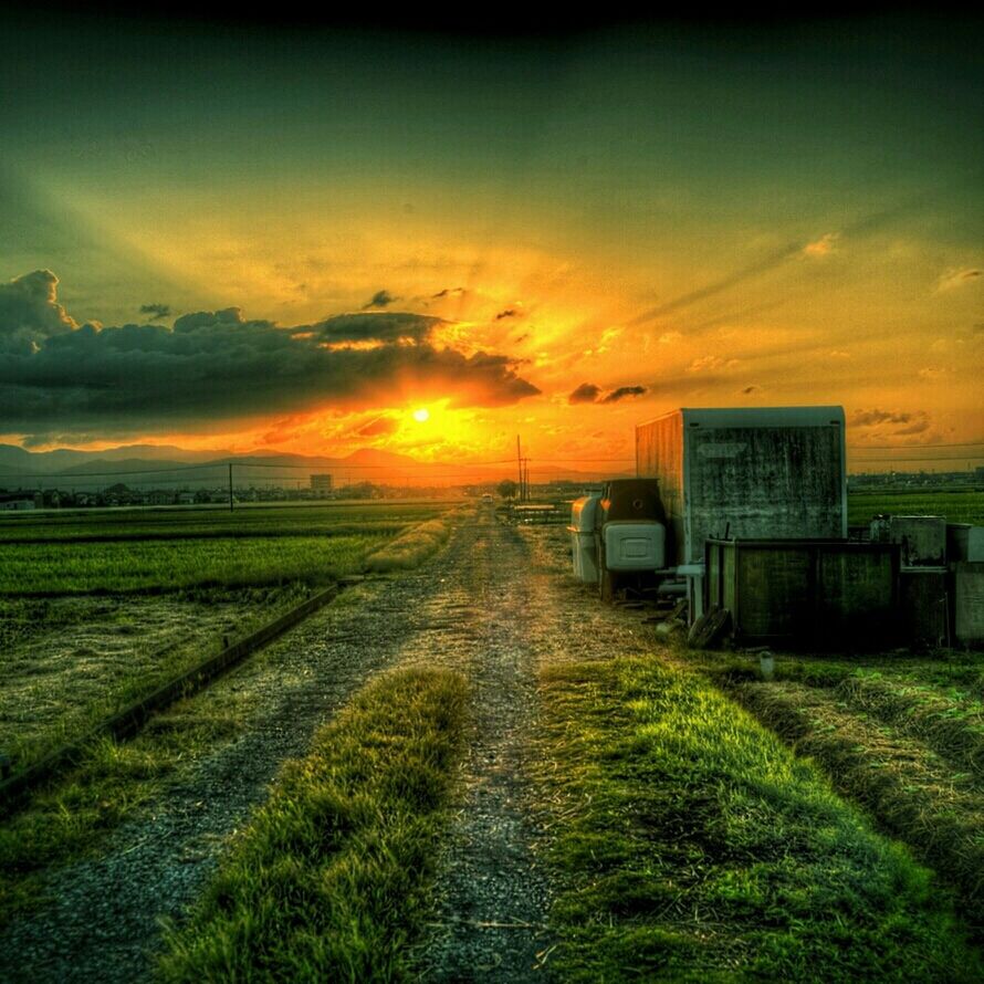 sunset, sky, field, the way forward, landscape, cloud - sky, grass, rural scene, orange color, tranquil scene, tranquility, nature, building exterior, beauty in nature, scenics, diminishing perspective, built structure, dirt road, house, architecture