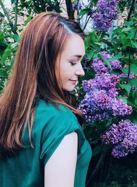 Beautiful young woman with purple flower