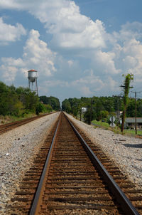 View of railroad tracks against cloudy sky