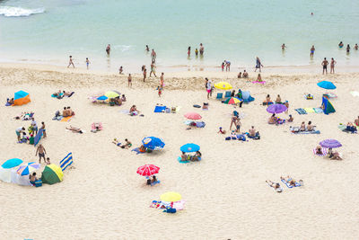 High angle view of people enjoying at beach