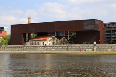 View of bridge over river against buildings