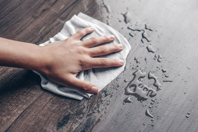 Close-up of hand touching text on wall