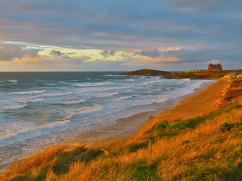 Scenic view of beach against sky during sunset