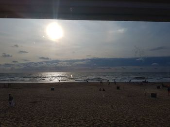 Scenic view of beach against sky during sunset