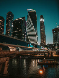 Illuminated modern buildings in city at night